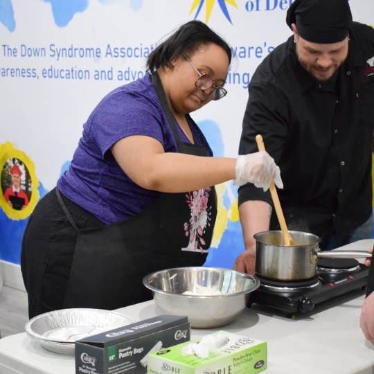 Cooking student mixing on stove
