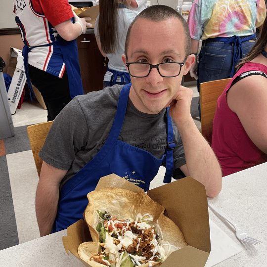 Cooking student posing with burrito bowl